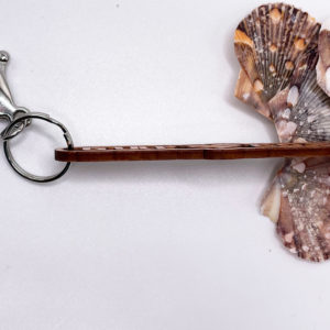 Siesta Key Gulf Coast Love Keychain souvenir with shells next to it the side view